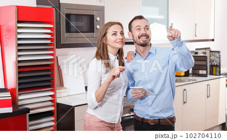 Couple discussing in furnishing store Couple discussing in furnishing store 102704110