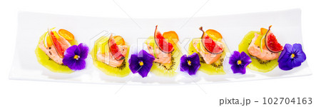 Ceviche of pickled salmon on kiwi with figs, cumquat 102704163