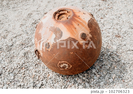 Old rusty sea mine on the beach. Old rusty sea mine on the beach. 102706323