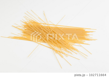 Spaghetti spread out on a white surface. Spaghetti spread out on a white surface. 102711664