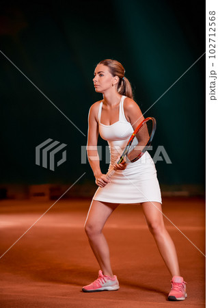 Indoor tennis court playing athlete. Indoor tennis court playing athlete. 102712568