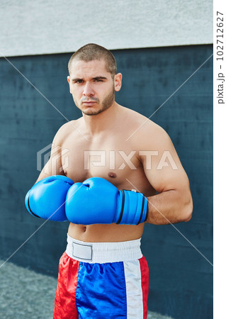 Boxer shorts and gloves practicing on the street Boxer shorts and gloves practicing on the street 102712627