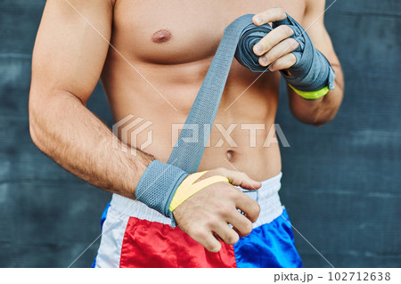 Close up of fit man wearing bandage on his hand 102712638