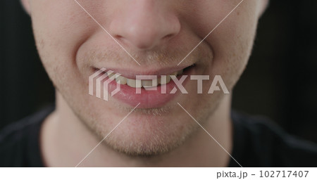 closeup shot of man mouth smiling 102717407