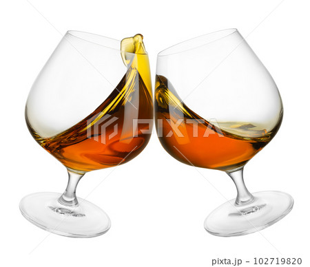 two glasses of brandy in toasting gesture with splash isolated on white 102719820