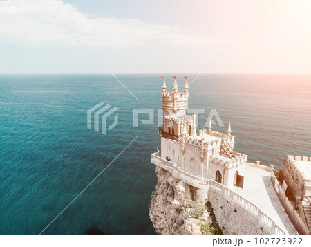 Crimea Swallow's Nest Castle on the rock over the Black Sea. It is a tourist attraction of Crimea. Amazing aerial view of the Crimea coast with the castle above abyss on sunny day. 102723922