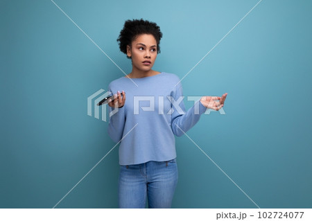 confused young brunette woman with afro curls throws up her hands confused young brunette woman with afro curls throws up her hands 102724077