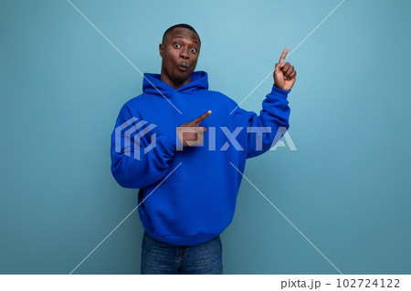 authentic ethnic young african man in stylish hoodie on blue background 102724122