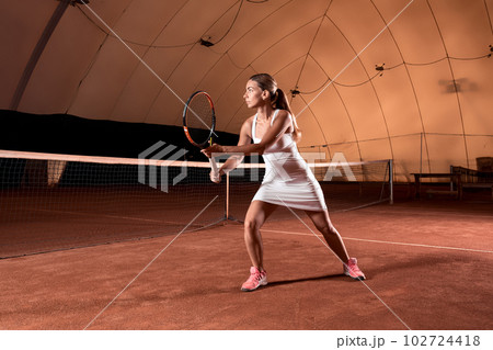 Sportswoman at the tennis court with racquet. Sportswoman at the tennis court with racquet. 102724418
