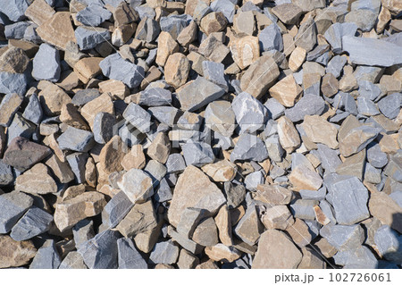 Gravel texture. Pebble stone background. Light grey closeup small rocks. Top view of ground gravel road. 102726061