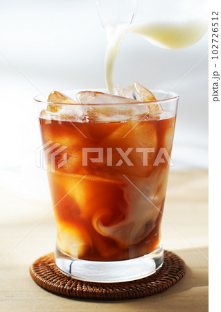 アイスティーに冷たいミルクを注ぐ。 102726512