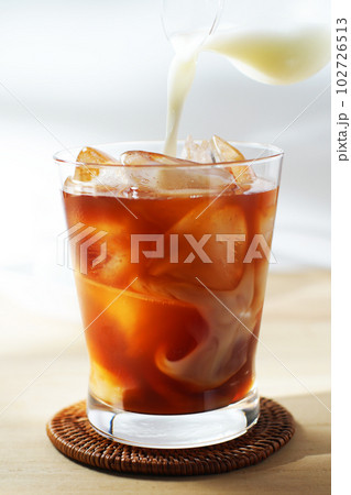 アイスティーに冷たいミルクを注ぐ。 102726513