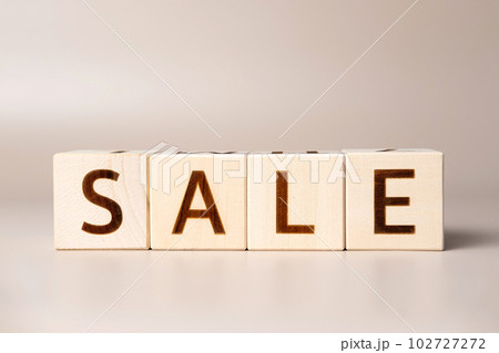 The word SALE on wooden cubes on a beige neutral studio background. Copy Space. Written. Text words matter. Conceptual Photo. Shopping symbol. The concept of volume increase make business grow The word SALE on wooden cubes on a beige neutral studio background. Copy Space. Written. Text words matter. Conceptual Photo. Shopping symbol. The concept of volume increase make business grow 102727272
