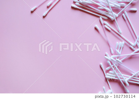 cotton swabs on a pink background on the right, cosmetic and medical accessories, a beauty salon banner, with a place for text cotton swabs on a pink background on the right, cosmetic and medical accessories, a beauty salon banner, with a place for text 102730114