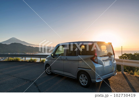 Minivan car at Satta pass against mt. Fuji and sunrise, Shizuoka 102730419