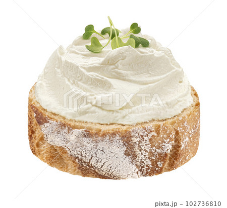 Baguette slice with cream cheese swirl isolated on white background Baguette slice with cream cheese swirl isolated on white background 102736810