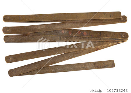 Antique carpenter's brass ruler from isolated on white. Antique carpenter's brass ruler from isolated on white. 102738248