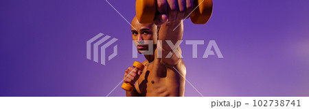 Muscular man doing exercise with weight dumbbells on studio background. Strength and motivation 102738741