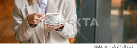 Close up of businesswoman having coffee break time during working day in cafe 102738813