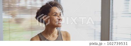 Afro american sporty woman sit on floor and preparing for online fitness class from home Afro american sporty woman sit on floor and preparing for online fitness class from home 102739531