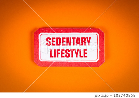 Sedentary Lifestyle. Sticky note with text on an orange background Sedentary Lifestyle. Sticky note with text on an orange background 102740858