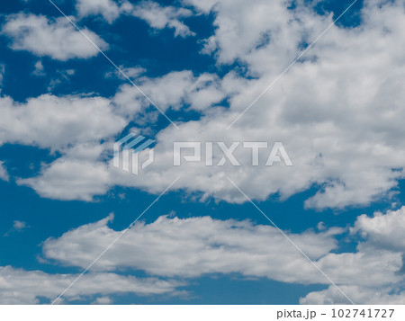 Thick white cumulus clouds in the blue sky Thick white cumulus clouds in the blue sky 102741727