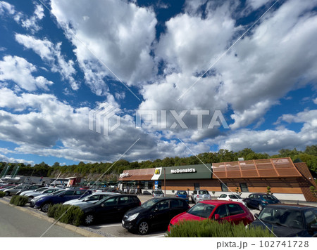 Large crowded parking lot with cars near the McDonalds building Large crowded parking lot with cars near the McDonalds building 102741728