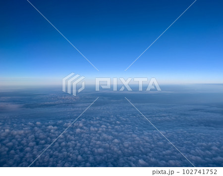 Airplane view of white cumulus clouds on turquoise horizon Airplane view of white cumulus clouds on turquoise horizon 102741752