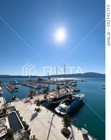 Luxury marina with moored yachts surrounded by mountains 102741753
