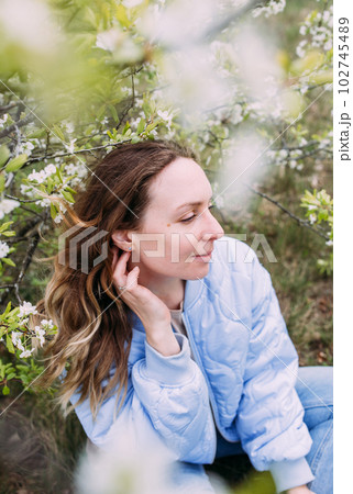 Portrait of a young woman in spring in a park 102745489