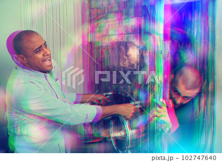 Young people having fun in quest room Young people having fun in quest room 102747640