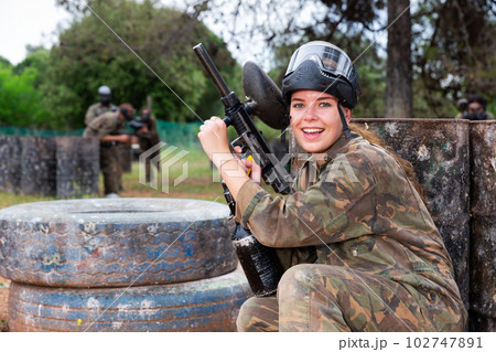 Portrait of girl in camouflage on paintball field Portrait of girl in camouflage on paintball field 102747891