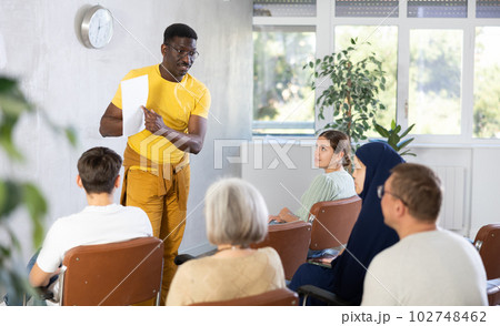 African american male teacher lecturing to students at auditorium 102748462