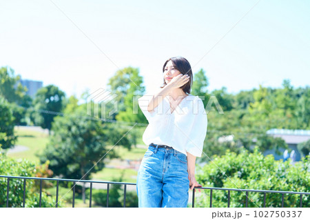 屋外で光を浴びる女性 102750337