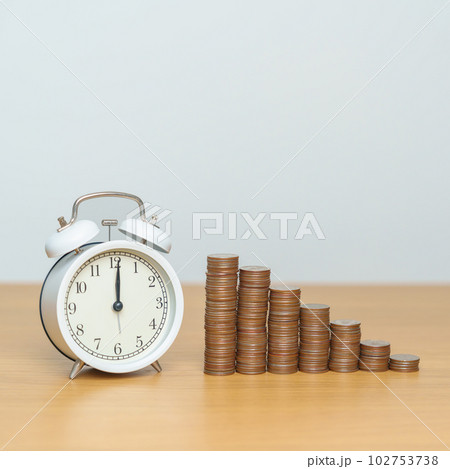 Money Saving for Future Plan, Retirement fund, Pension, Investment, Wealth Business and Financial concepts. coins money stack with clock on table 102753738