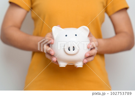 Money Saving for Future Plan, Retirement fund, Pension, Investment, Wealth Business and Financial concepts. hand holding piggy bank, Money Counting for World Savings day and Donate 102753789