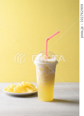 Pineapple smoothie with sliced pineapple fruit, Tropical summer drink 102762909