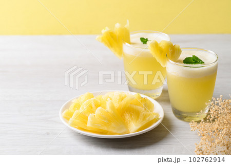 Pineapple smoothie in glass with sliced pineapple fruit, Tropical summer drink 102762914