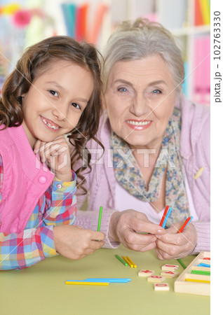 grandmother with granddaughter counting with sticks grandmother with granddaughter counting with sticks 102763330