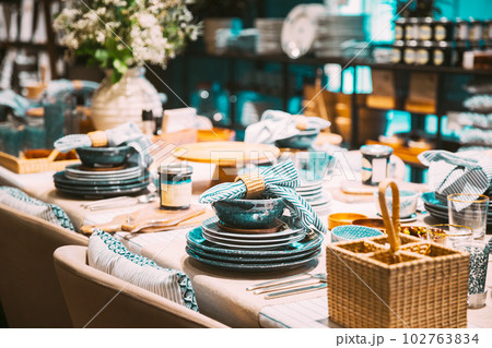 View of assortment of decor for interior shop in store of shopping center. Home accessories and household products for dining room in store of shopping centre. View of dinnerware on table. Home View of assortment of decor for interior shop in store of shopping center. Home accessories and household products for dining room in store of shopping centre. View of dinnerware on table. Home 102763834