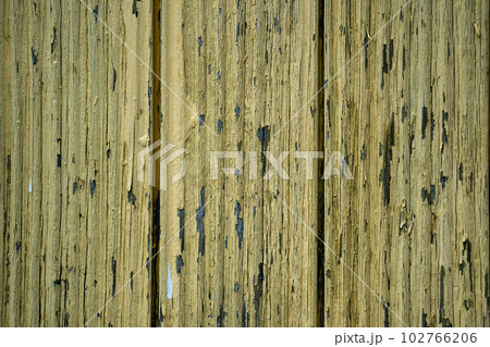 Old cracked yellow paint on boards 102766206