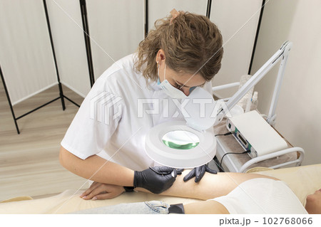 Hair Removal Process With Electrolysis On Hand Of White Young Woman, Cosmetologist Does Electric Epilation In Beauty Salon. Horizontal Plane. Authentic Photo Hair Removal Process With Electrolysis On Hand Of White Young Woman, Cosmetologist Does Electric Epilation In Beauty Salon. Horizontal Plane. Authentic Photo 102768066