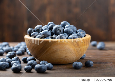 Fresh blueberry in wooden bowl. Concept of healthy and dieting eating. 102775790