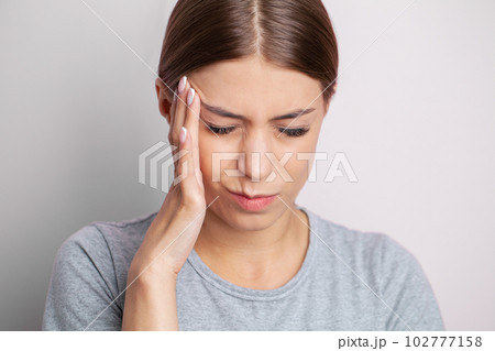 Feeling strong headache massaging temples exhausted from overwork, fatigued overwhelmed lady. Feeling strong headache massaging temples exhausted from overwork, fatigued overwhelmed lady. 102777158