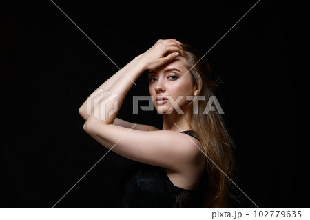 gorgeous brunette woman with long hair in black dress 102779635