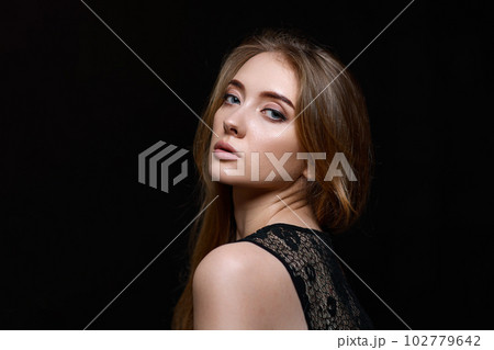 gorgeous brunette woman with long hair in black dress 102779642