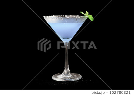 Blue Lagoon or Blue Hawaii Cocktail - A summer alcoholic drink with vodka, tonic, and water on black background Blue Lagoon or Blue Hawaii Cocktail - A summer alcoholic drink with vodka, tonic, and water on black background 102780821