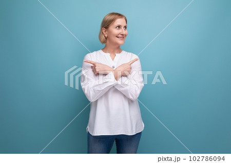 healthy slim blond mature woman smiling on studio background healthy slim blond mature woman smiling on studio background 102786094