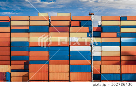 Stacked cargo containers in port. Industrial Container yard for Logistic Import Export business. loading containers box from cargo for import export. Logistic, transportation, import and export 102786430