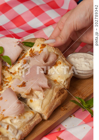 tasty cream-based pizza with ham and mushrooms 102789342